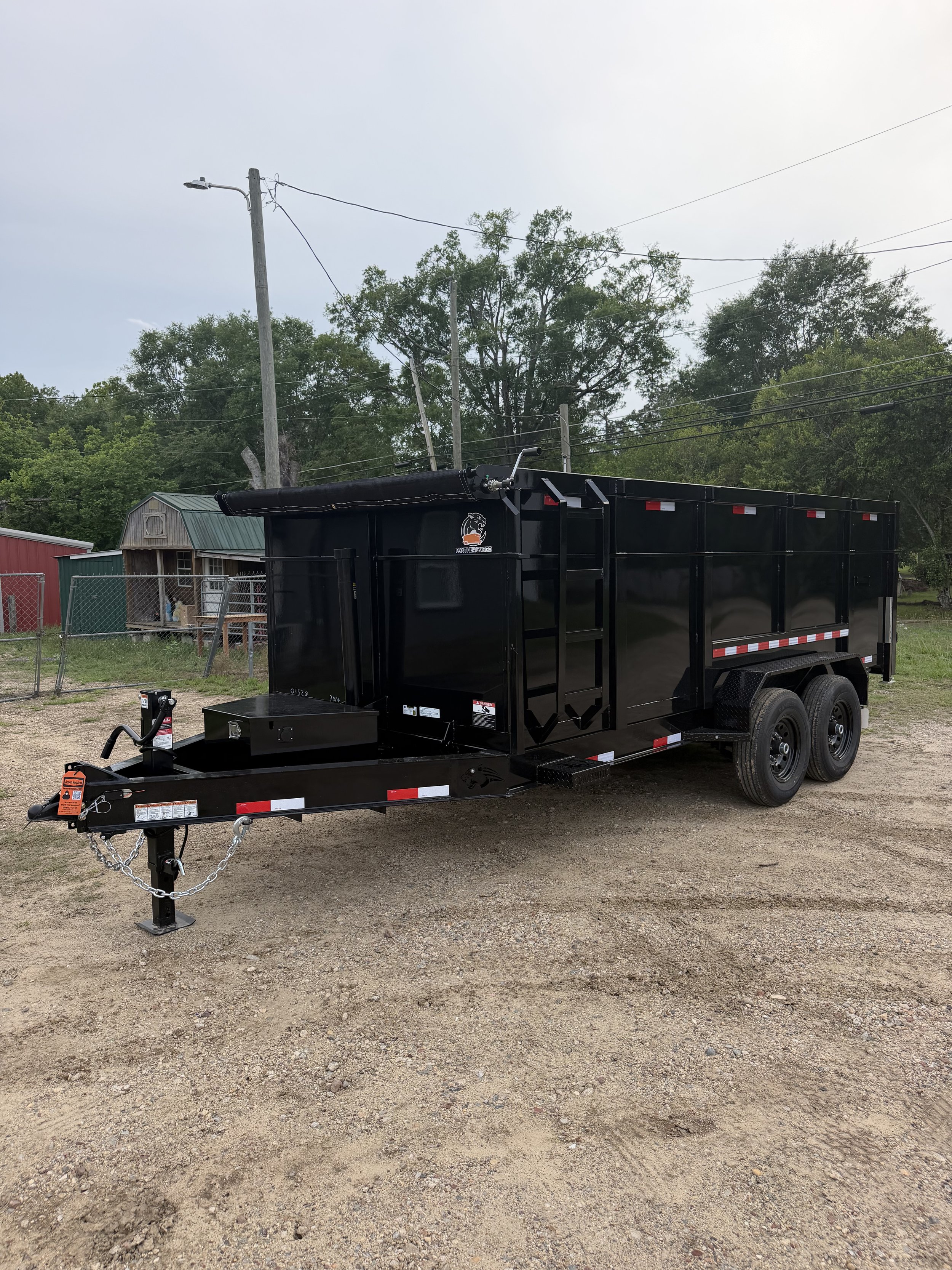 Reference photo of a black 7 by 16 foot dump trailer with four-foot walls
